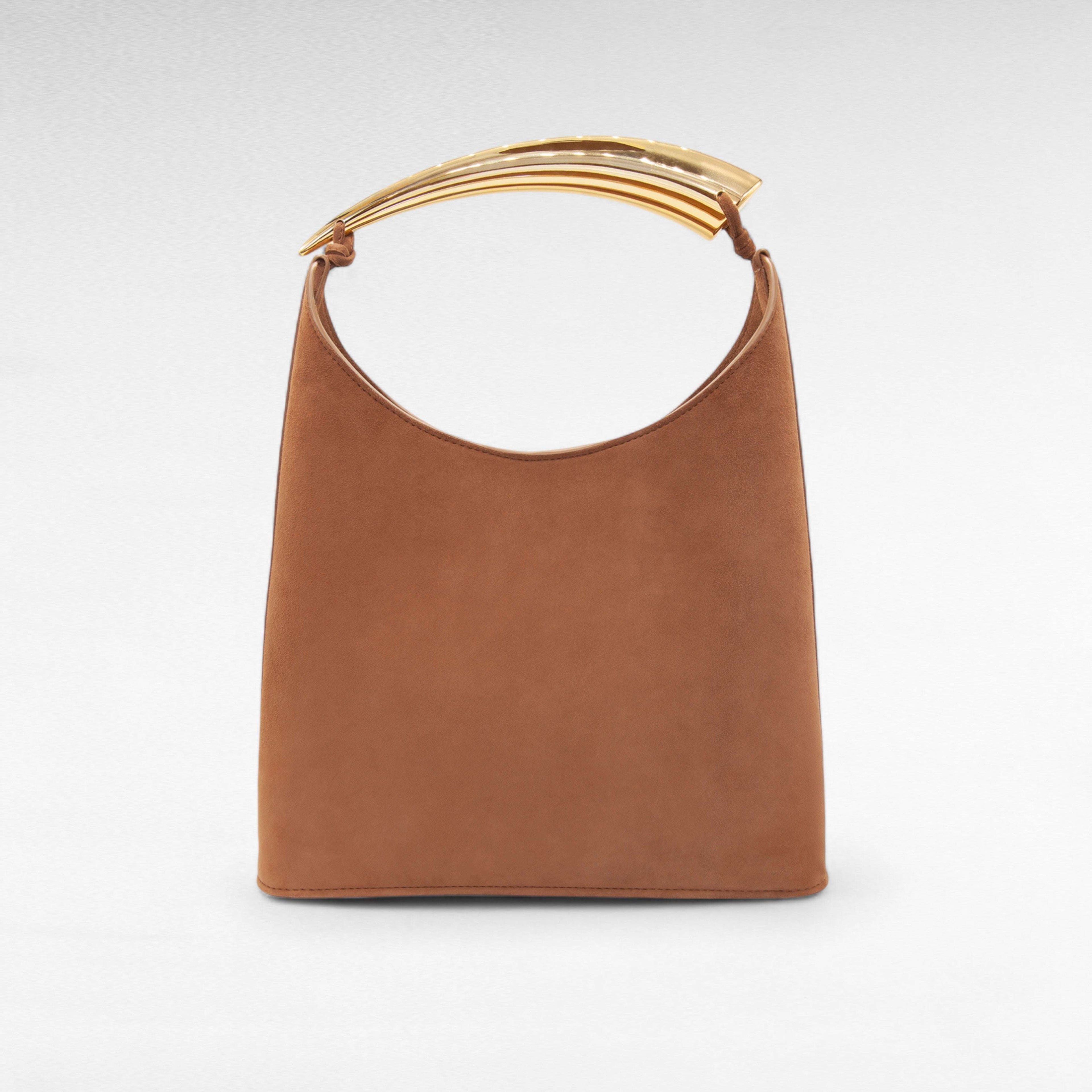 Brown suede handbag with sculptural gold handle and small zip pouch
