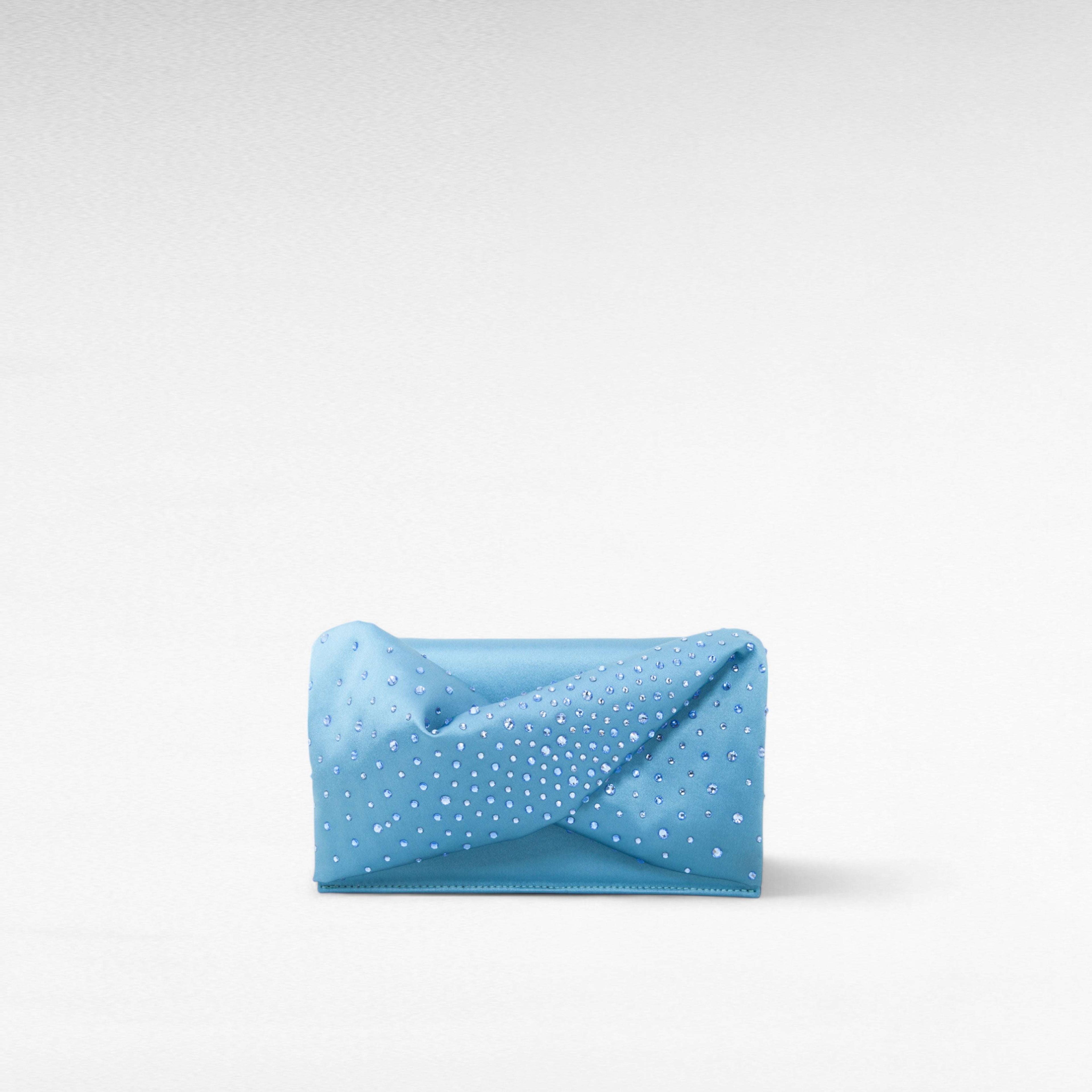Blue hand-held clutch bag with crystal and front bow twist
