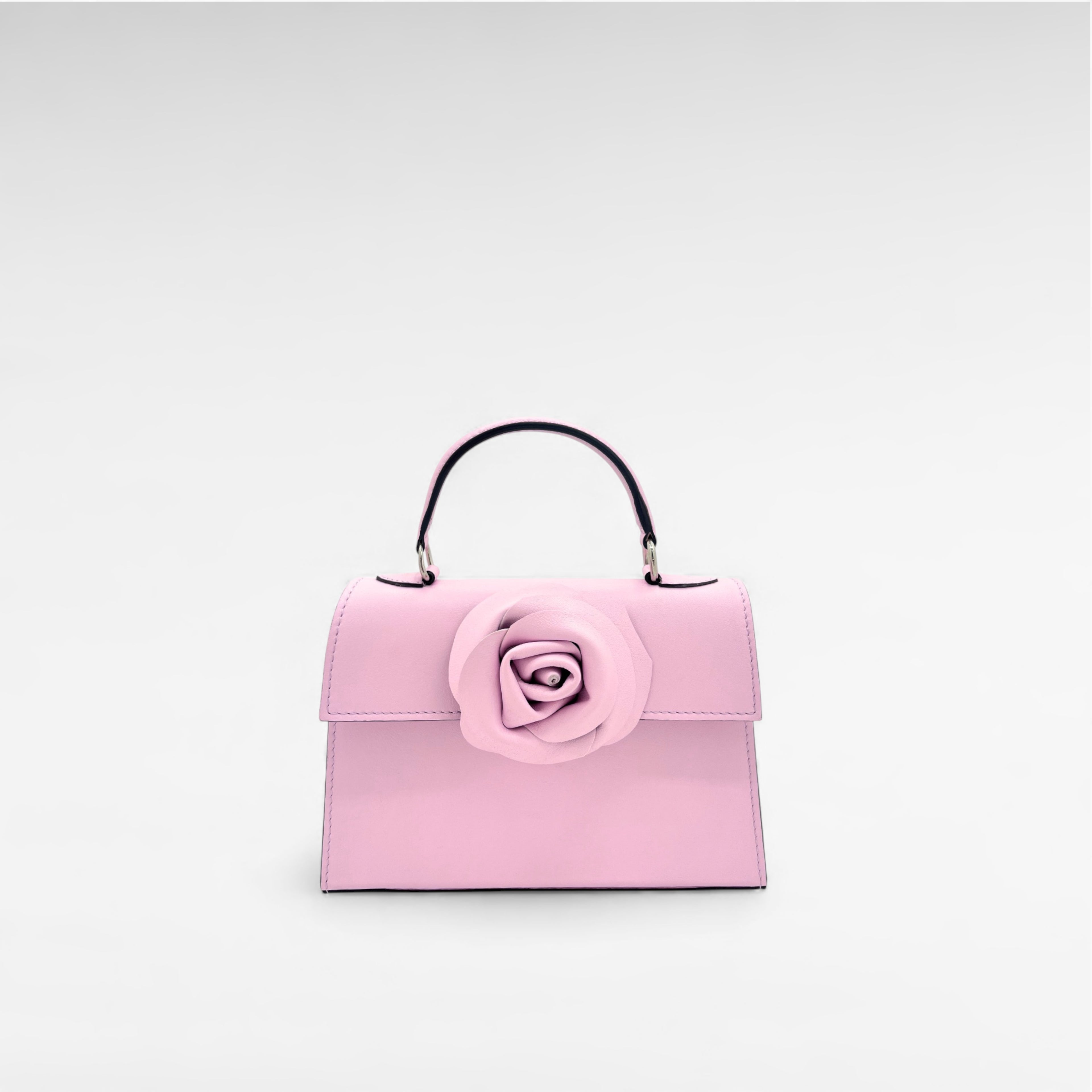 Pink mini leather handbag with flower and top handle